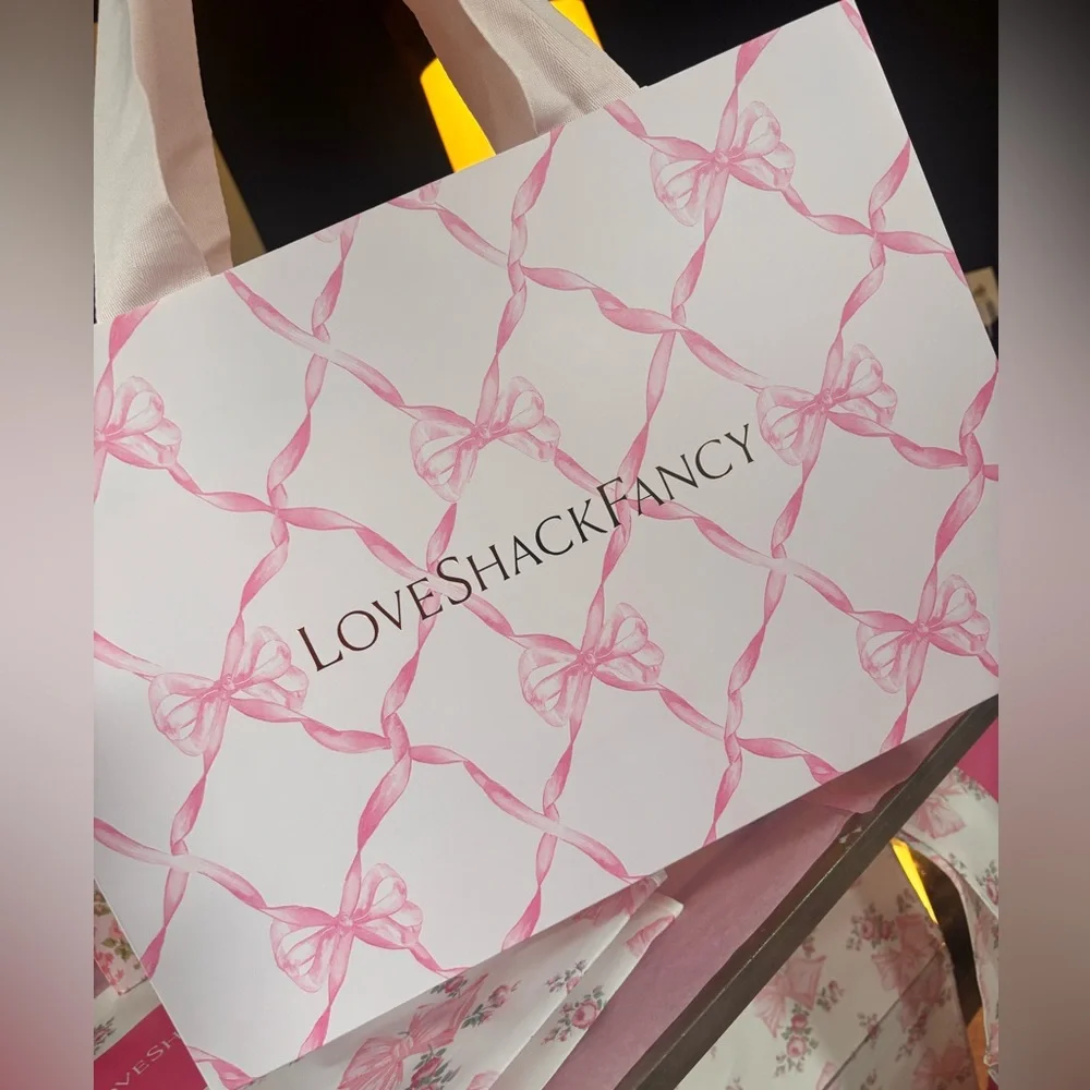 LoveShackFancy pink shopping gift bags with pink ribbon bow pattern